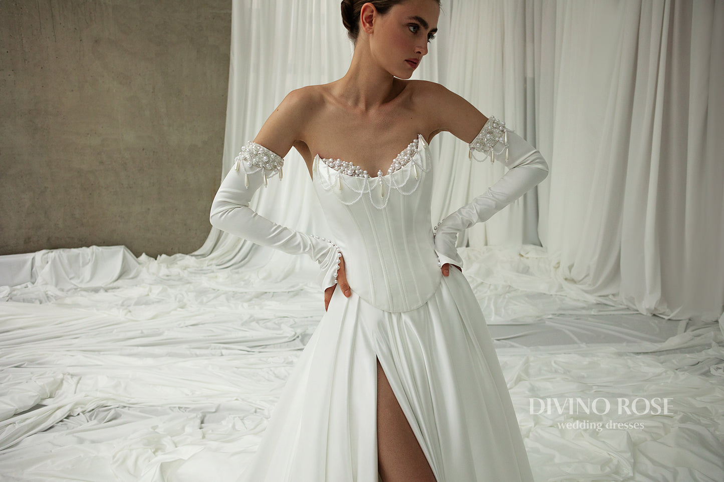 A-line wedding gown with detachable sleeves and flowing chapel train.