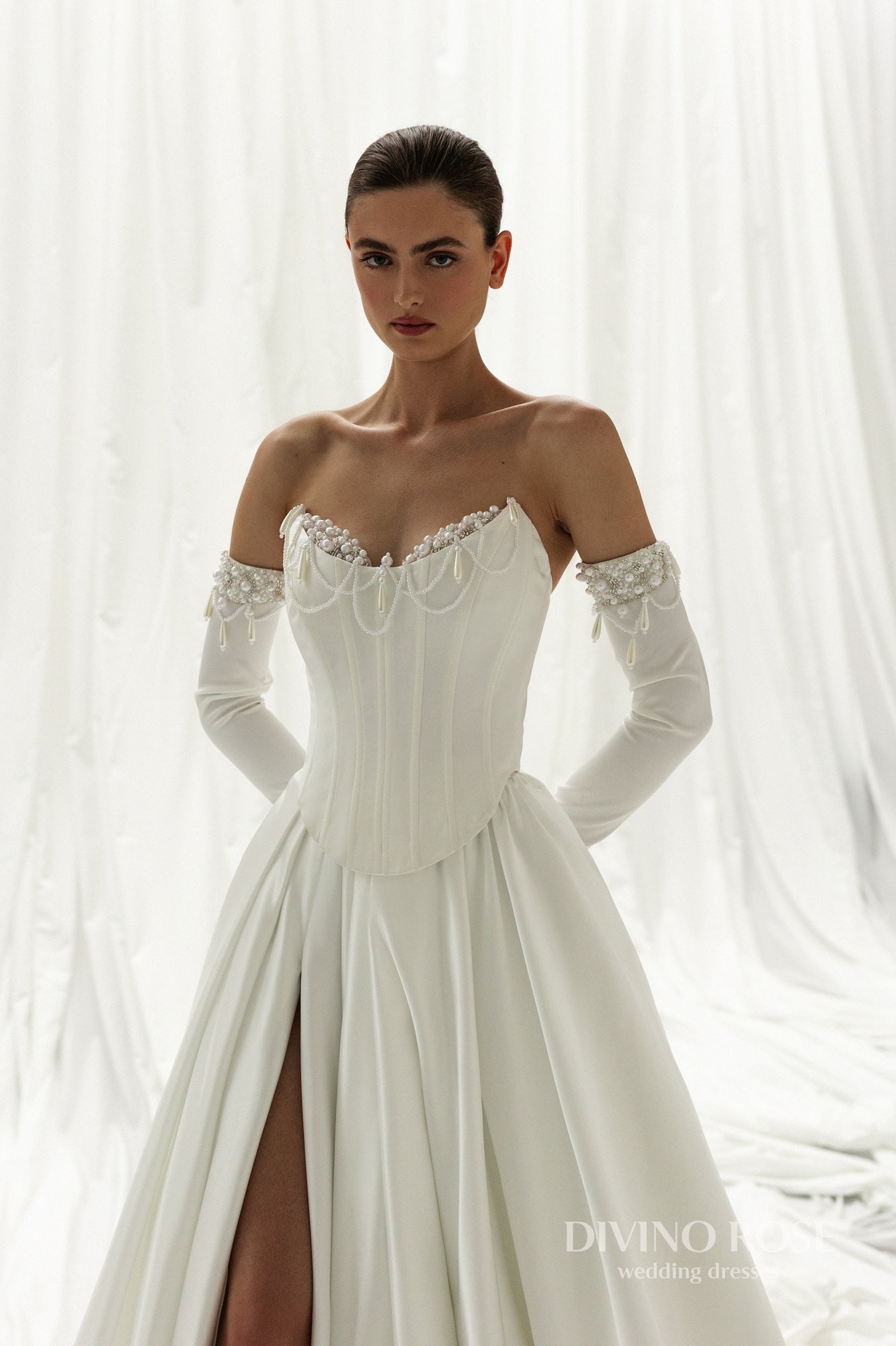 Chapel train bridal gown with boat neckline and long removable sleeves.
