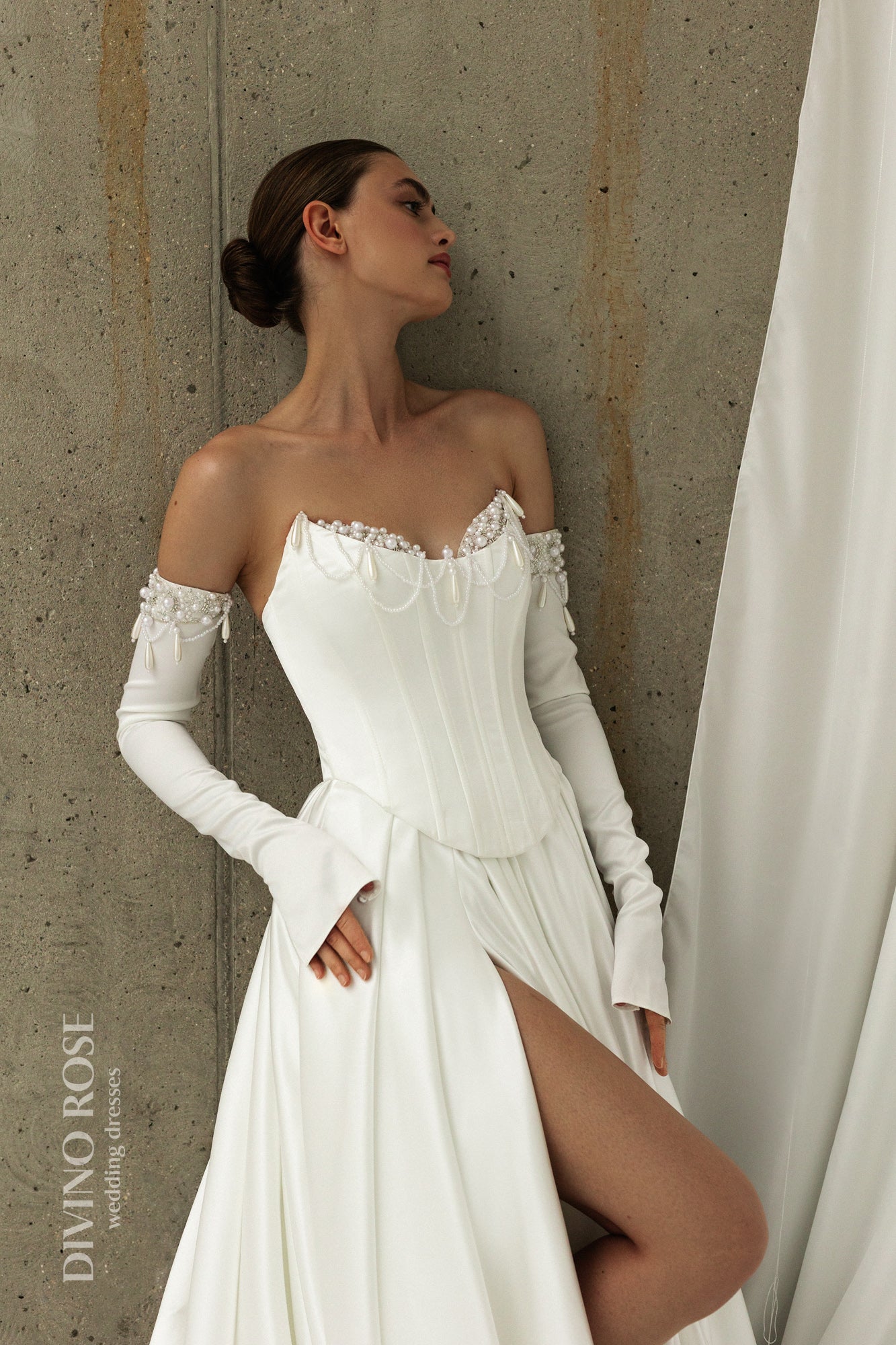 Classic A-line wedding dress with corset and pleated atlas skirt.