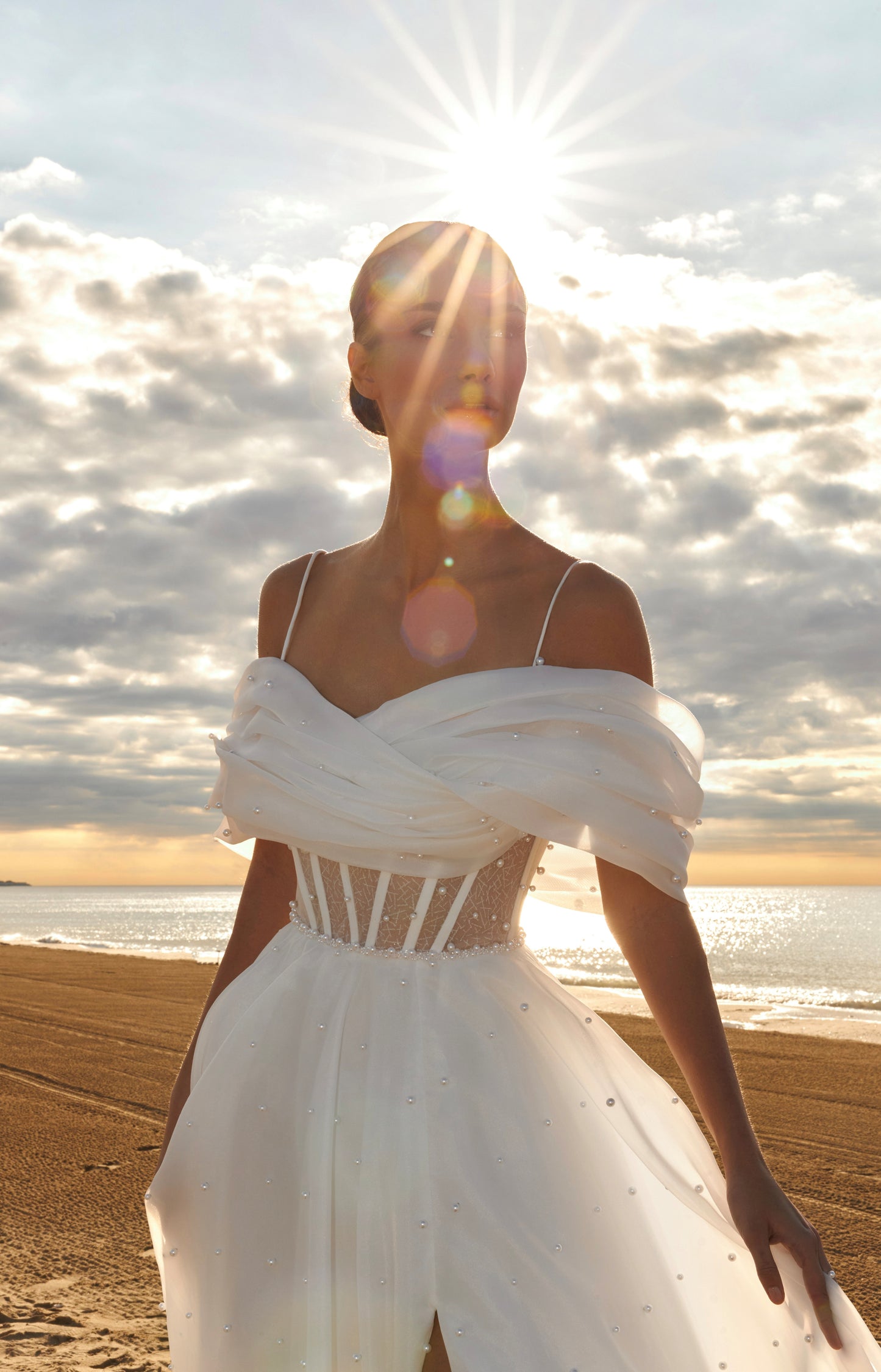 Organza A-line bridal gown with off-shoulder crossed draped neckline, spaghetti straps, pearl details, slit skirt, open back lace-up closure, and court train.