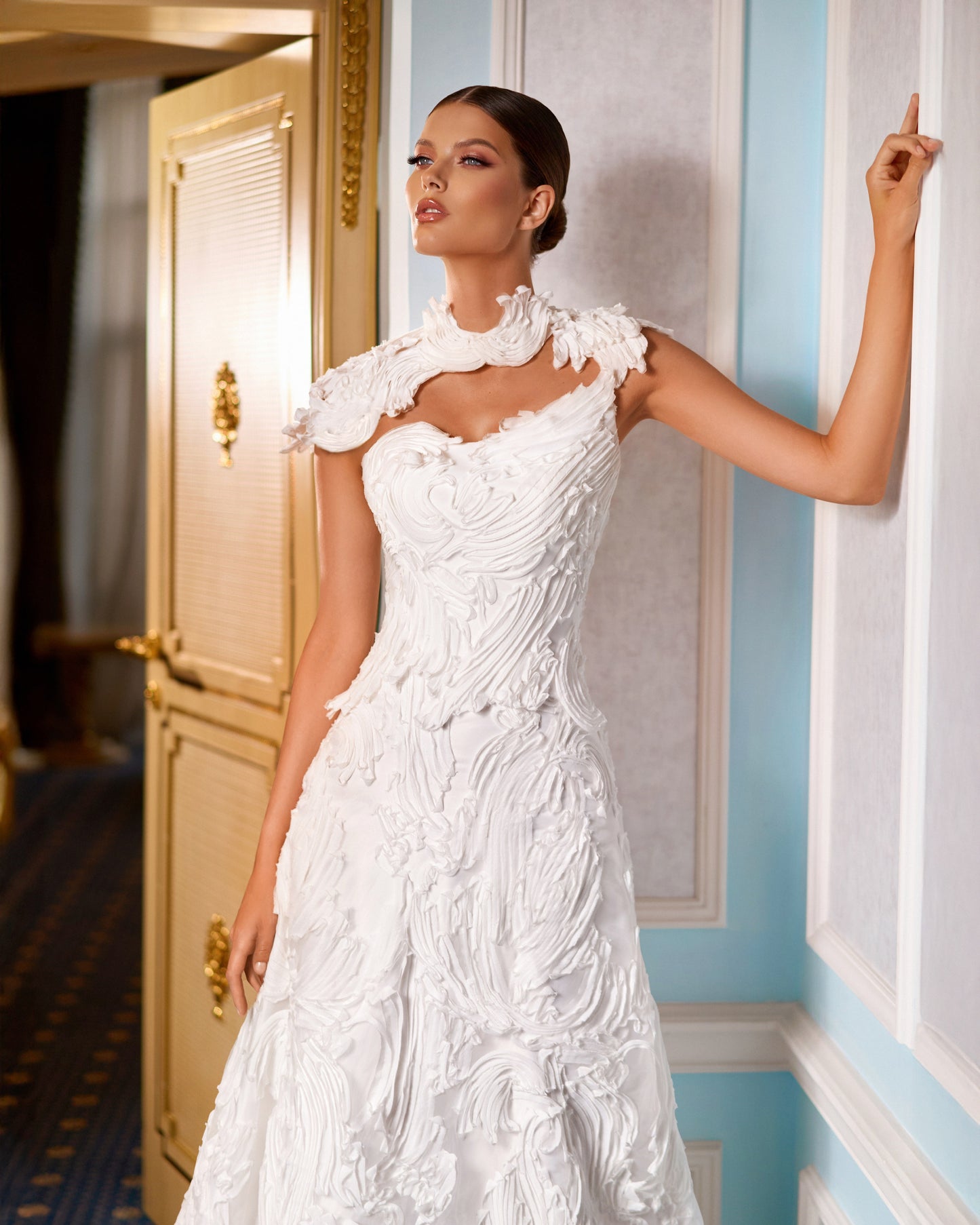 Explore this sculpted lace A-line wedding dress with removable bolero, strapless bodice option, and chapel train. A couture bridal gown offering elegance and versatility.