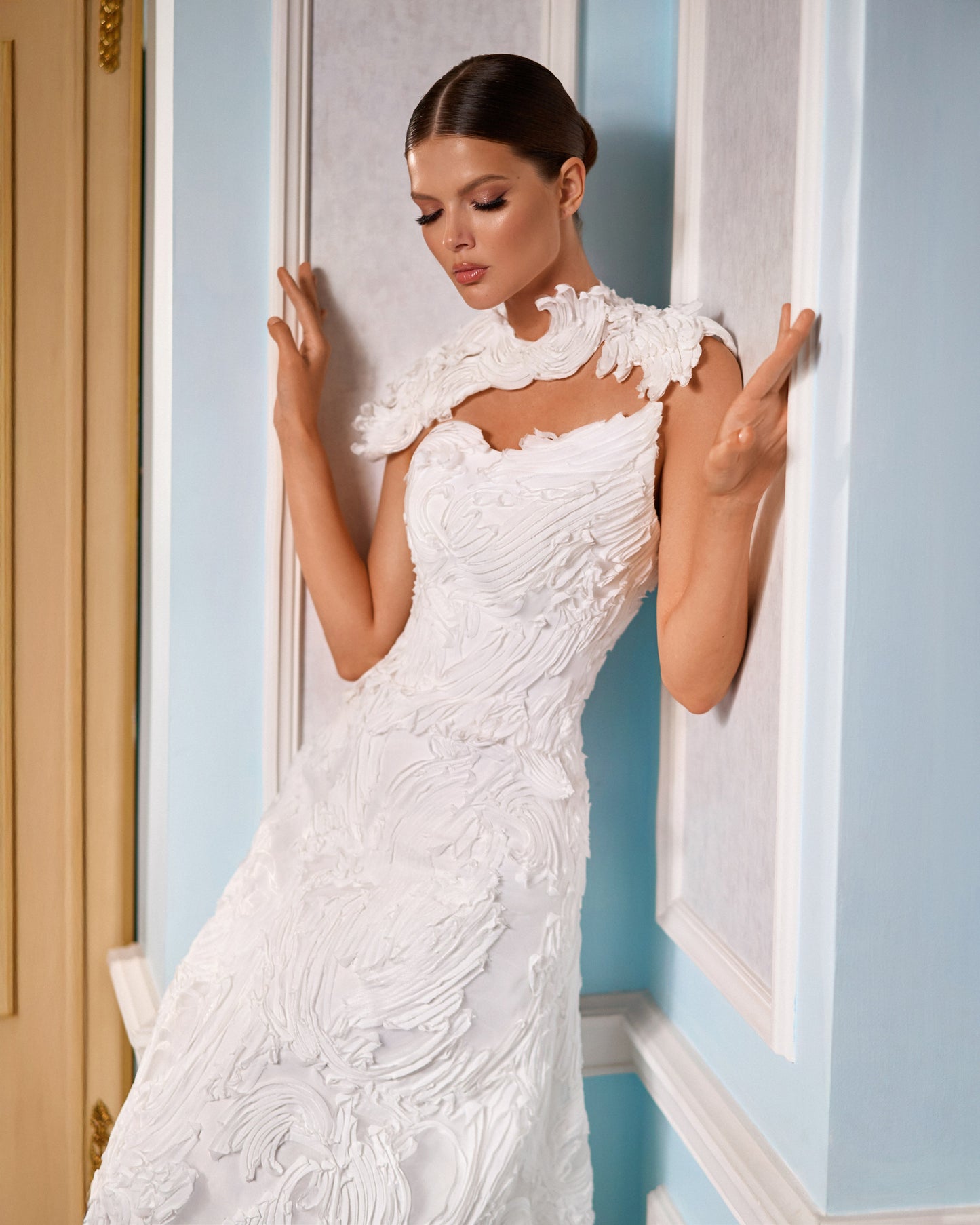 Explore this sculpted lace A-line wedding dress with removable bolero, strapless bodice option, and chapel train. A couture bridal gown offering elegance and versatility.