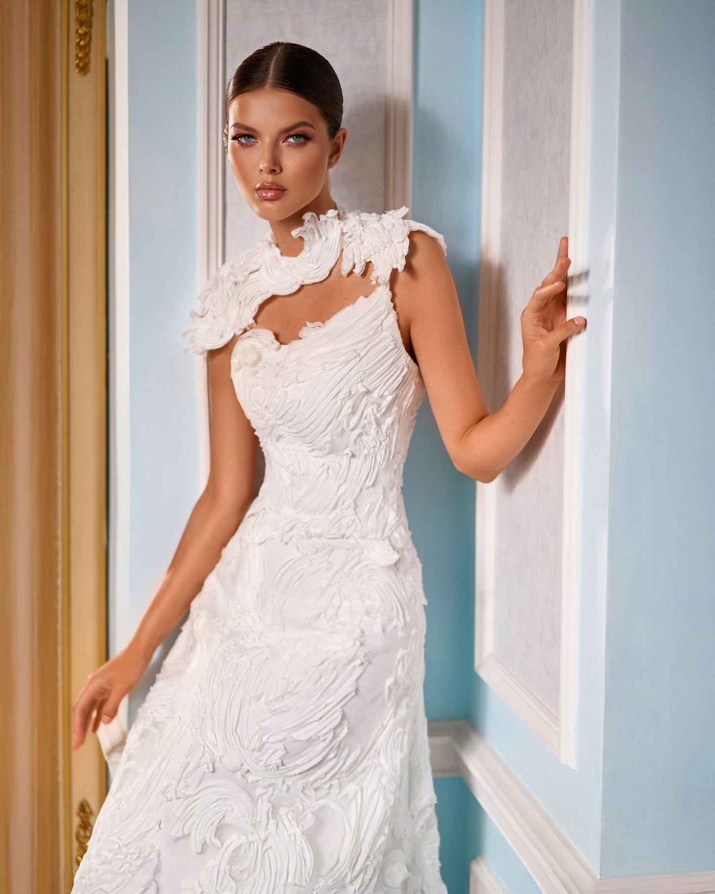 Explore this sculpted lace A-line wedding dress with removable bolero, strapless bodice option, and chapel train. A couture bridal gown offering elegance and versatility.