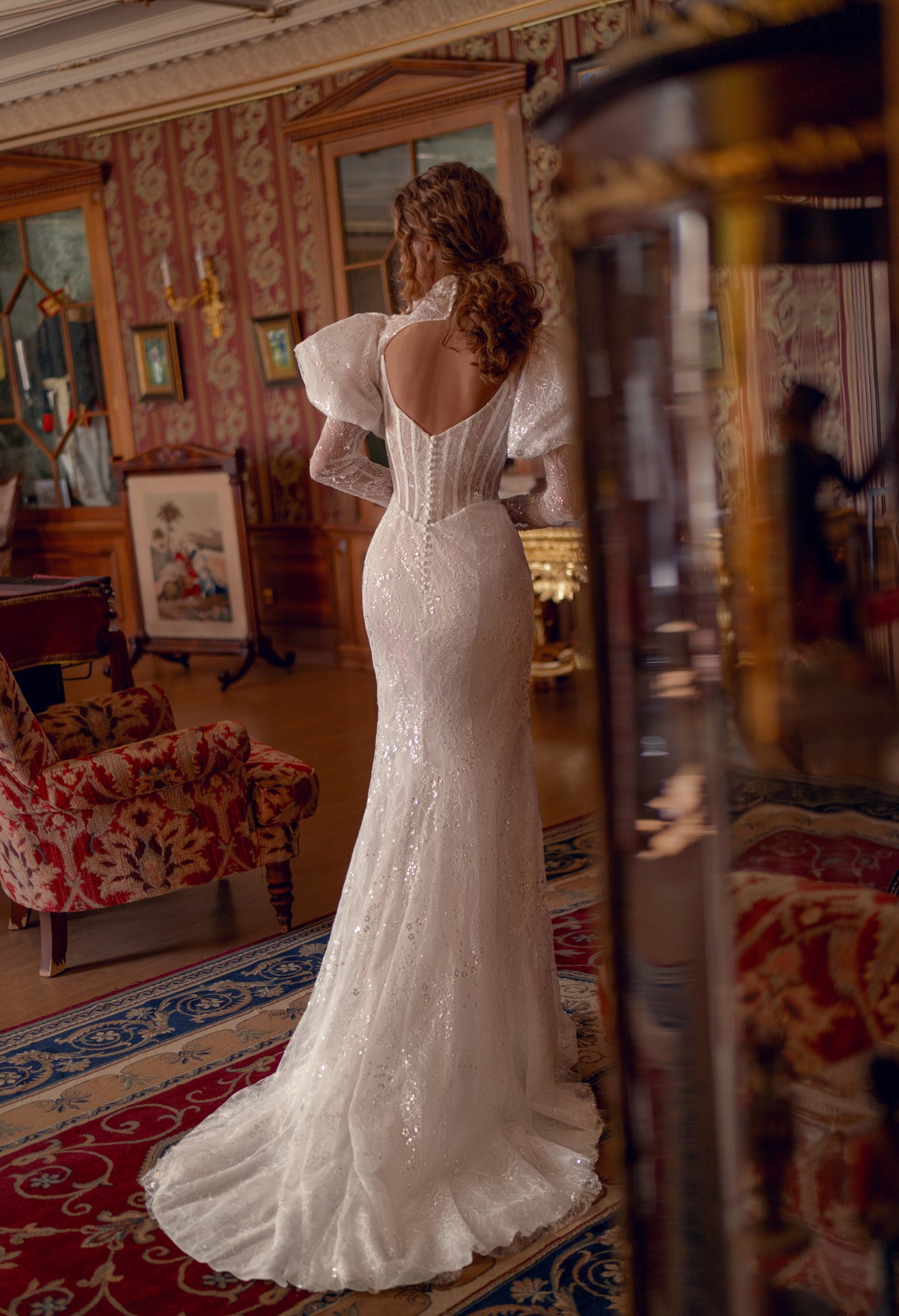 Bride wearing sculpted lace mermaid wedding gown with corset and optional bolero.