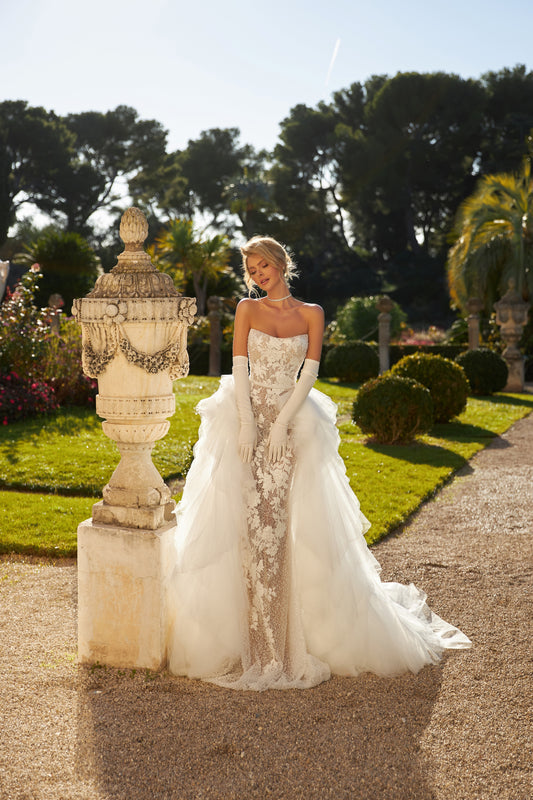 Fitted mermaid wedding dress with lace and open back.
