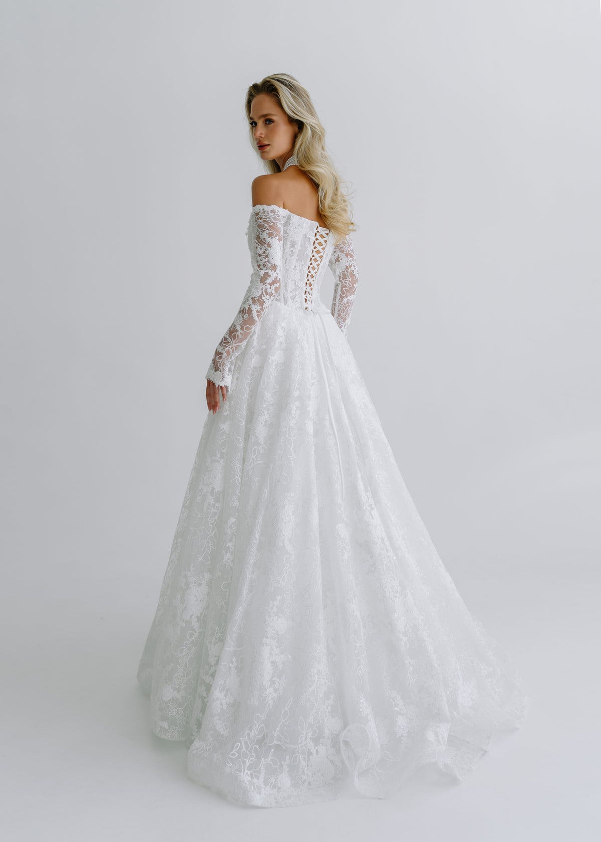 Back view of a sequin lace wedding dress with a lace-up back