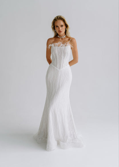 Sequin lace mermaid wedding dress with a feather-trimmed strapless neckline, front view
