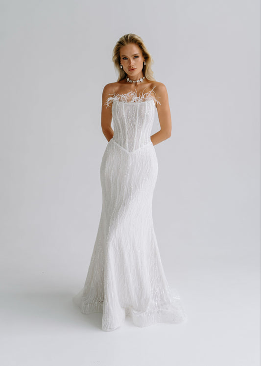Sequin lace mermaid wedding dress with a feather-trimmed strapless neckline, front view