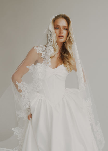 Satin A-line skirt and bodice with a long lace-trimmed veil