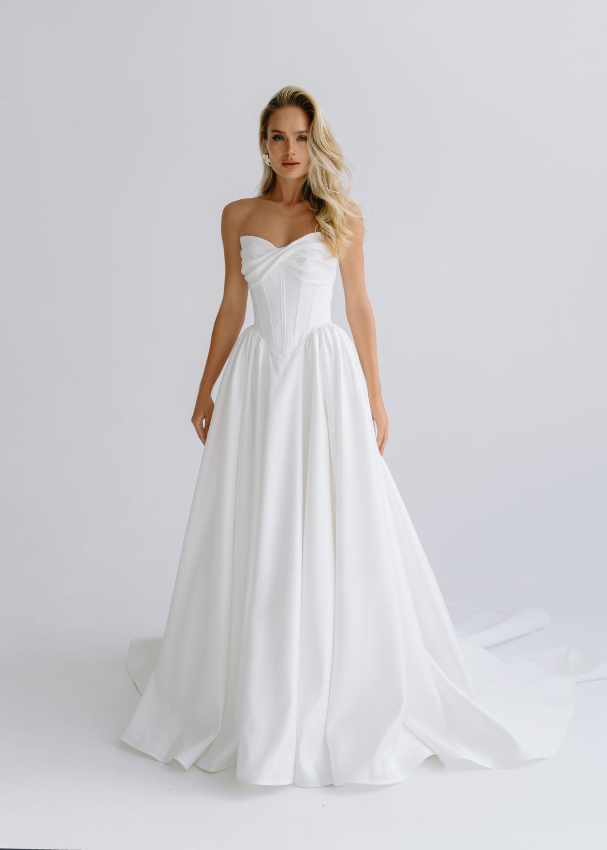 Strapless matte satin A-line wedding dress with a draped sweetheart bodice, front view