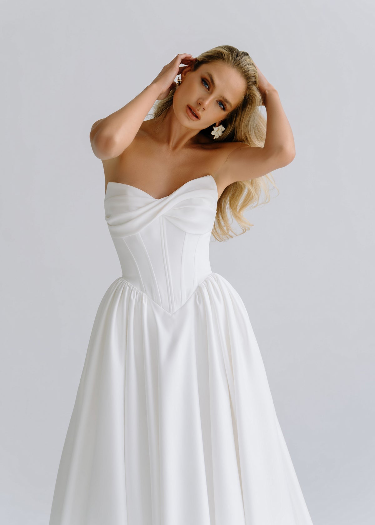 Close-up of a draped sweetheart satin bodice with a full skirt