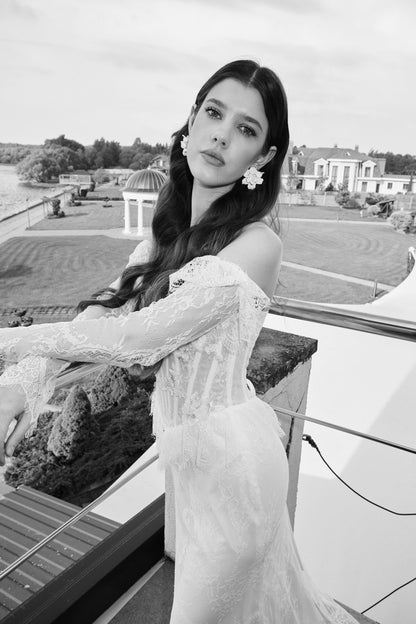 Black-and-white close-up of a lace sleeve and corset bodice