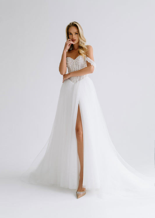 Tulle A-line wedding dress with an off-shoulder beaded corset and a high slit, front view