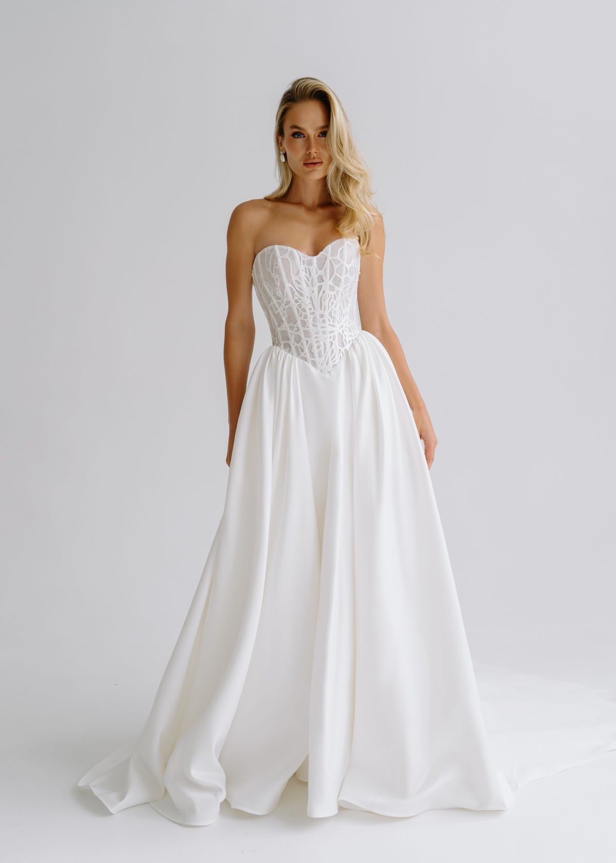 Strapless satin A-line wedding dress with a sweetheart lace corset, front view