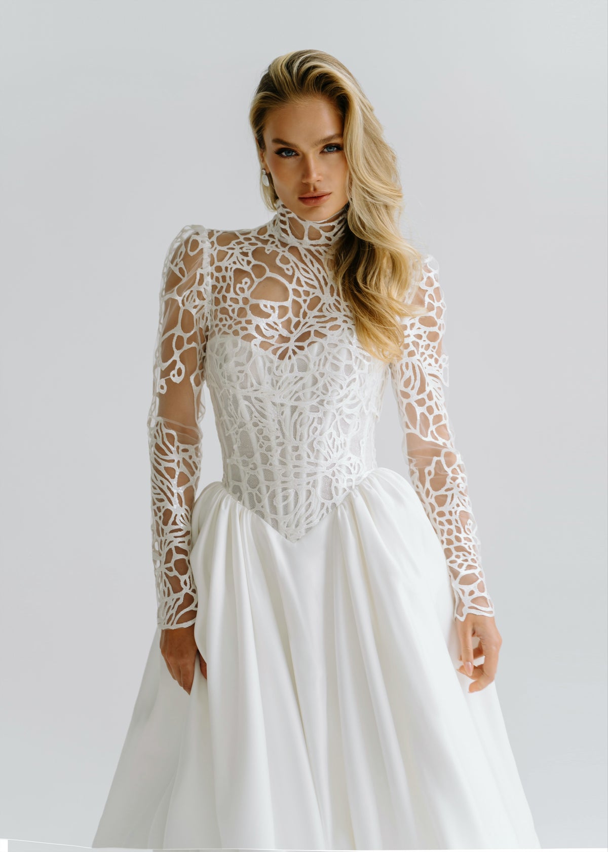 Satin wedding dress with a lace high-neck long-sleeve bolero over the corset