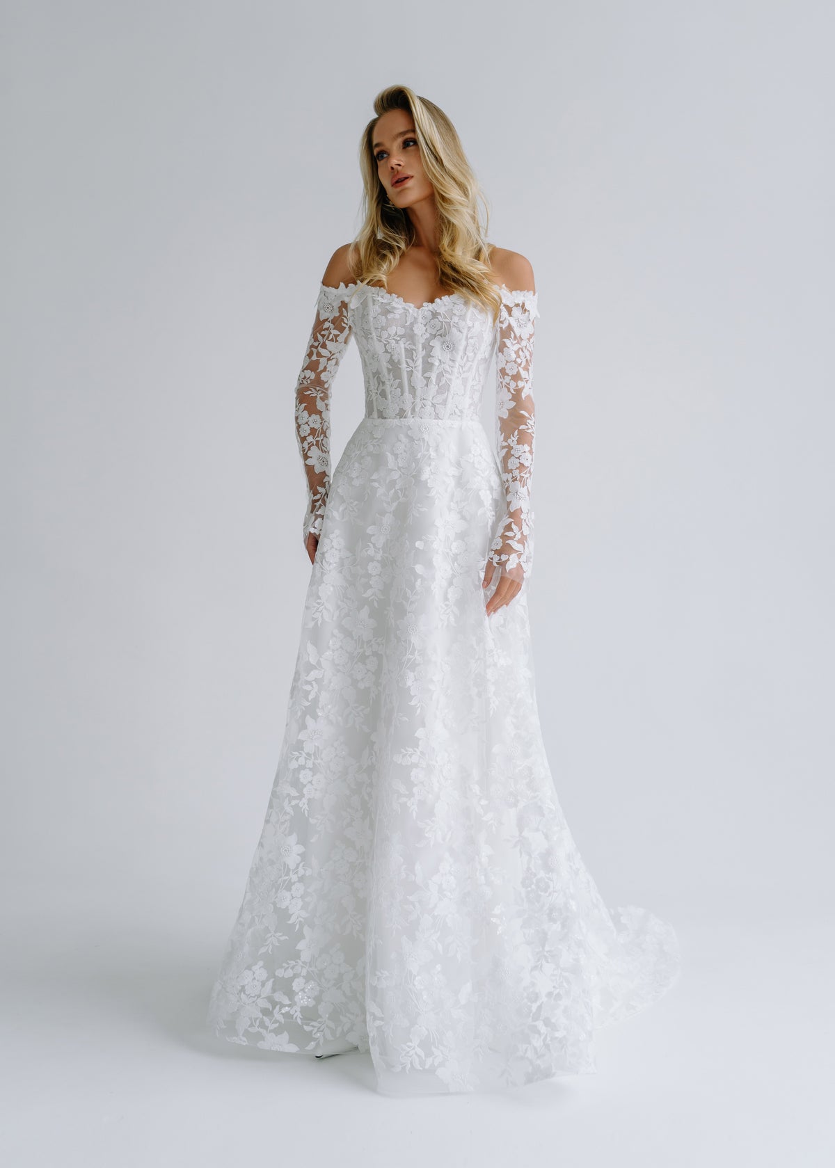 Floral lace A-line wedding dress with an off-shoulder corset and long lace sleeves, front view
