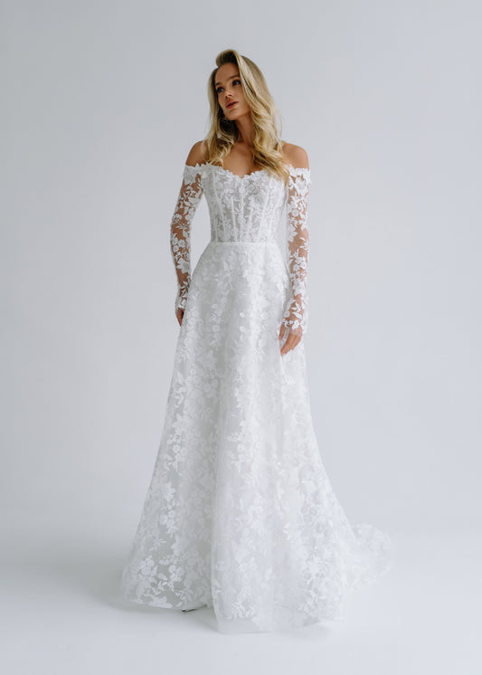Floral lace A-line wedding dress with an off-shoulder corset and long lace sleeves, front view