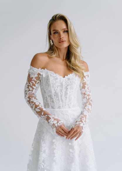 Close-up of an off-shoulder sweetheart lace corset with long floral lace sleeves