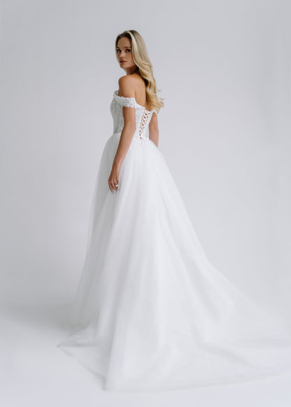 Back view of a tulle wedding dress with a lace-up back and a train