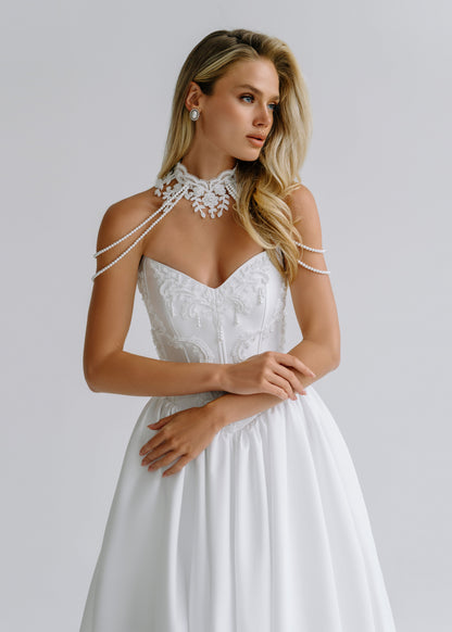Strapless embroidered bodice with a lace collar and chain-draped straps