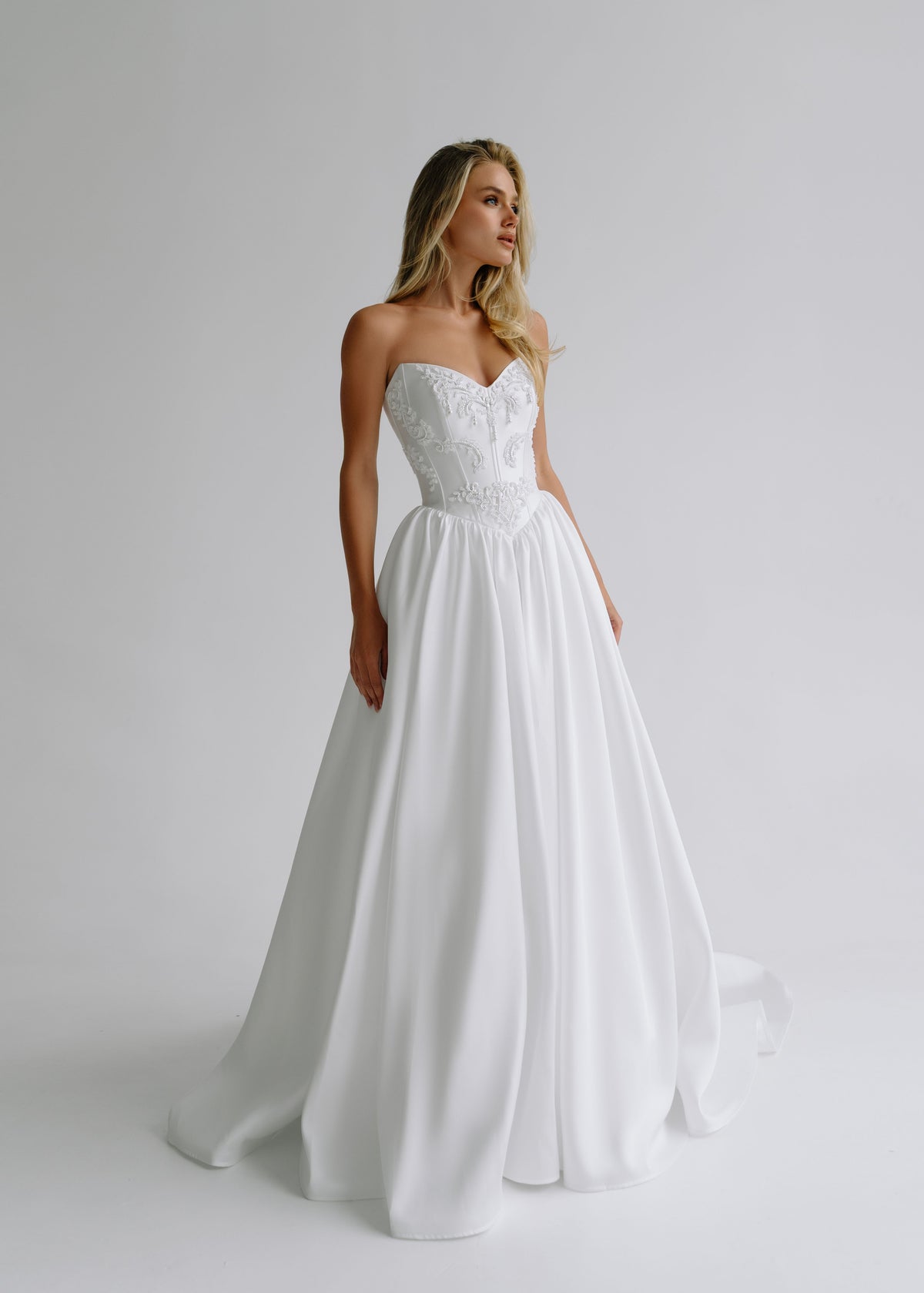 Strapless satin A-line wedding dress with an embroidered sweetheart bodice, front view