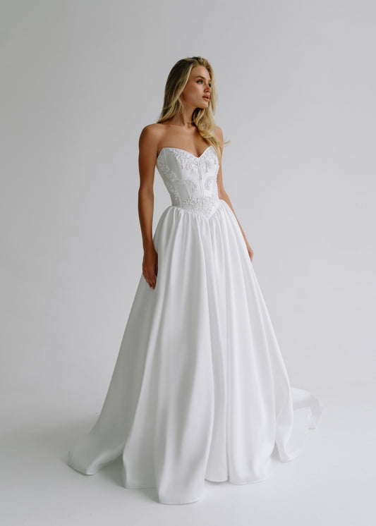 Strapless satin A-line wedding dress with an embroidered sweetheart bodice, front view
