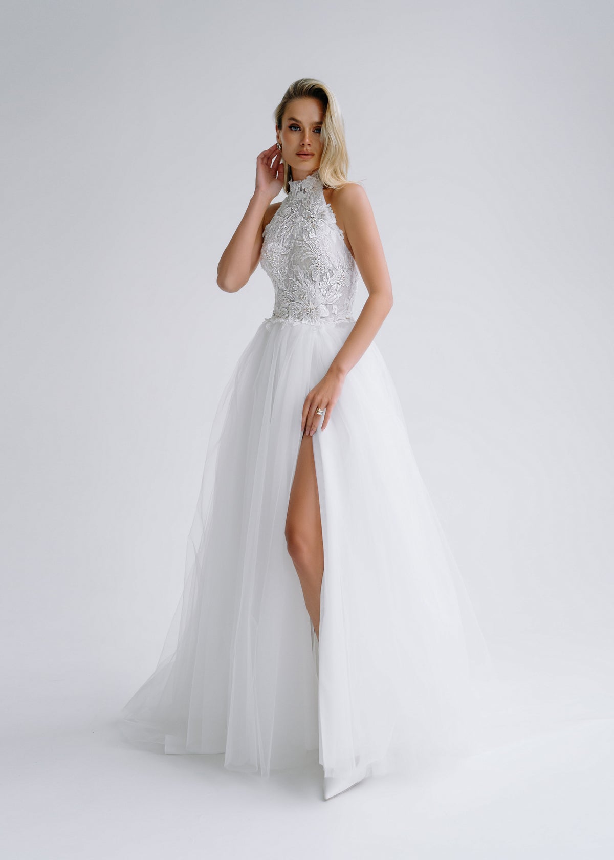 Tulle wedding dress with a halter beaded lace bodice and a high slit, front view