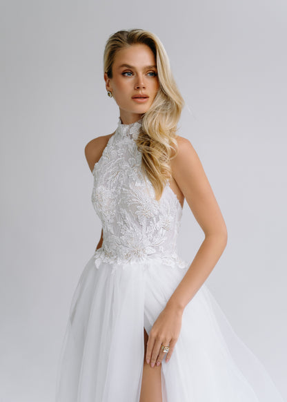 Close-up of a halter-neck beaded lace bodice over a slit tulle skirt