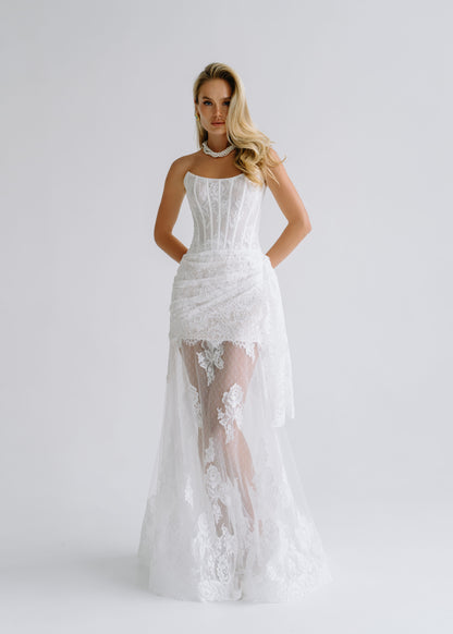 Strapless lace corset dress with a draped sheer overskirt, front view