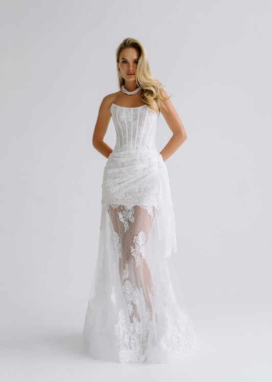 Strapless lace corset dress with a draped sheer overskirt, front view