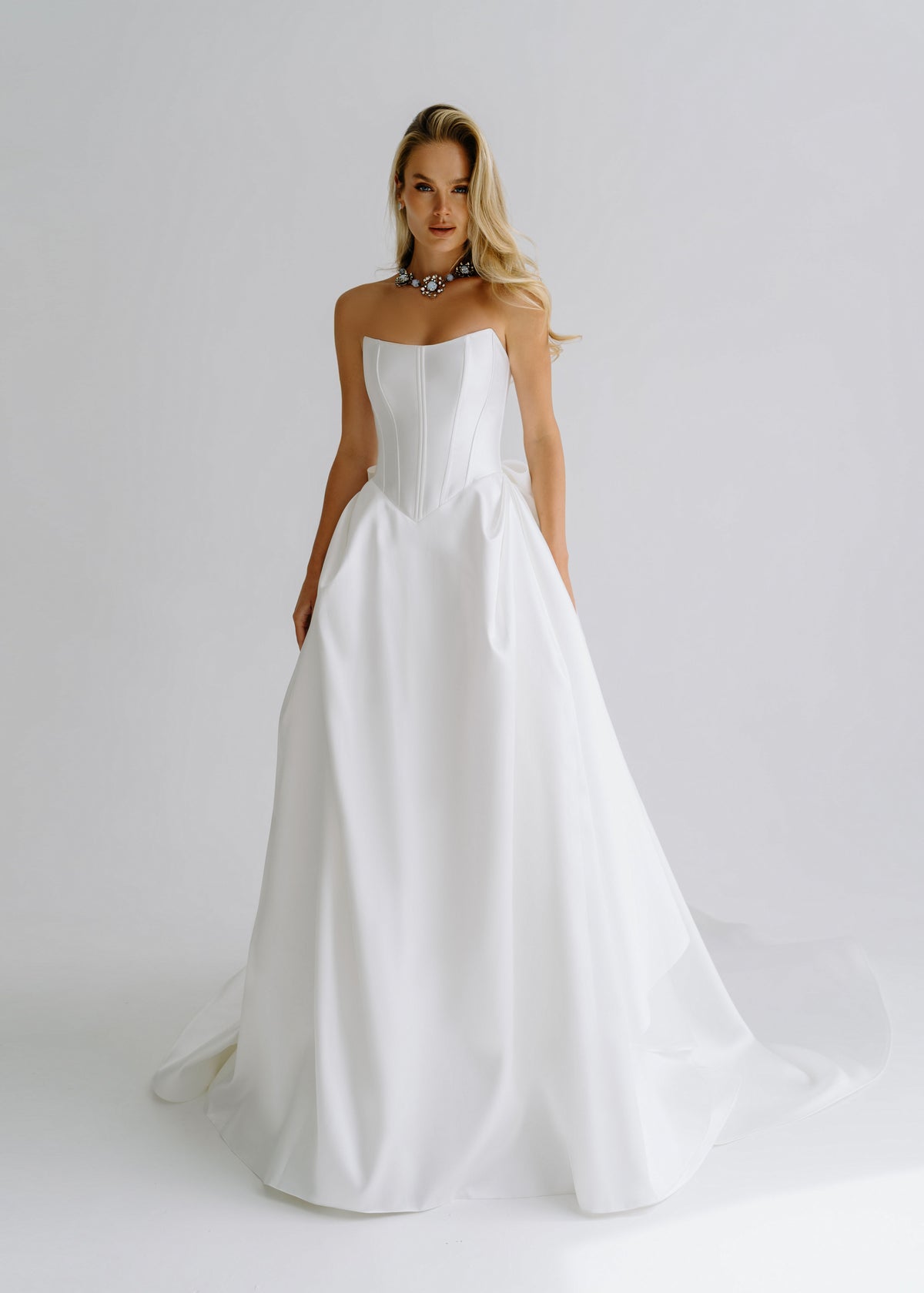 Strapless satin A-line wedding dress with a structured corset bodice, front view