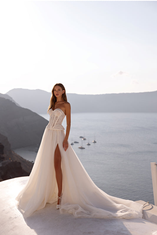 Strapless A-line wedding dress with lace corset and slit.