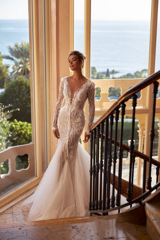 Fitted godet bridal gown with long sleeves, deep V-neckline, closed back, corded lace appliques, Chantilly lace, glitter tulle, and sweep train Wedding dress