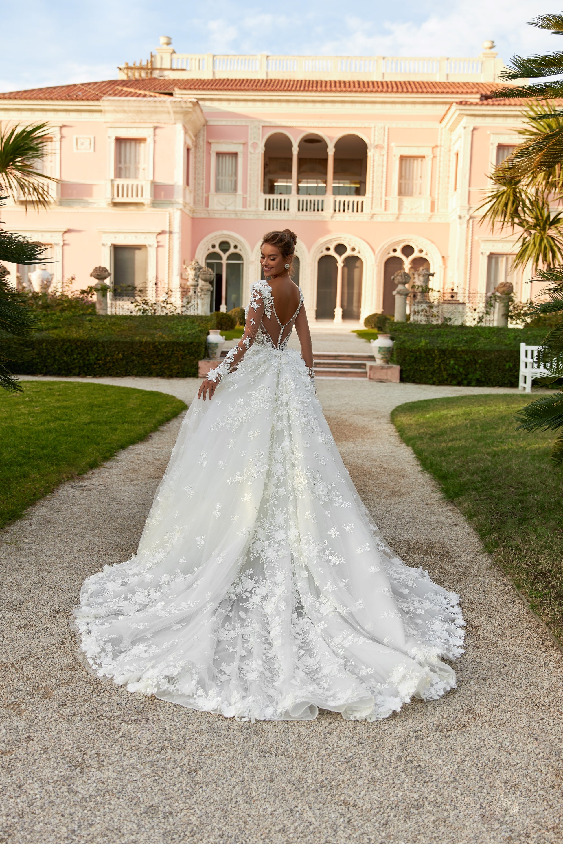 Fitted Mermaid wedding gown with illusion long sleeves, V-neckline, open V-shaped back, lace appliques, 3D flowers, bead and sequin embroidery, detachable chapel train overskirt, Chantilly lace.