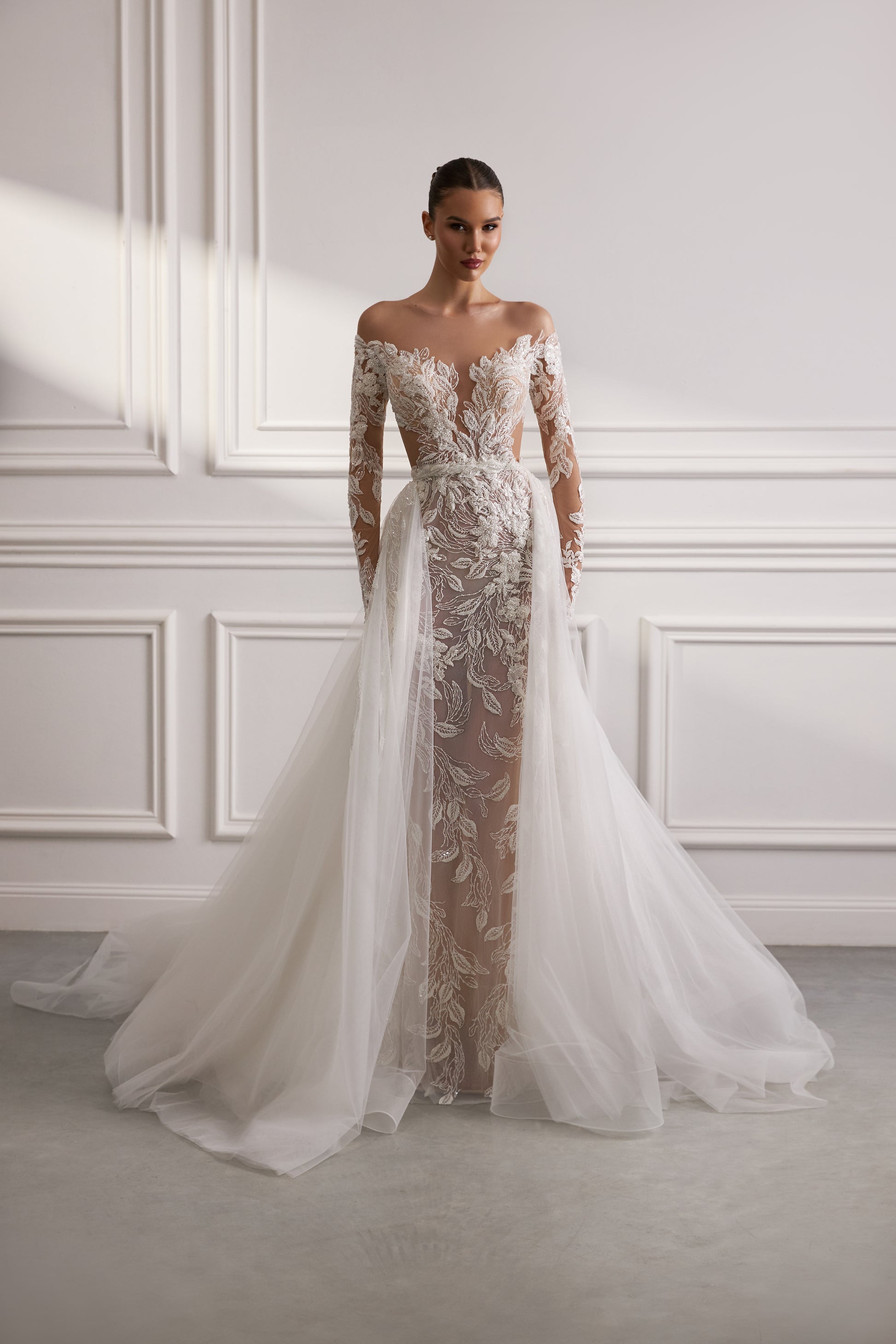 Sheath wedding dress with illusion sleeves and sweep train.