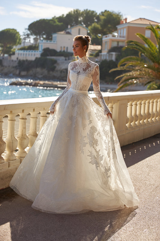 Halter wedding dress with cape and chapel train in lace.