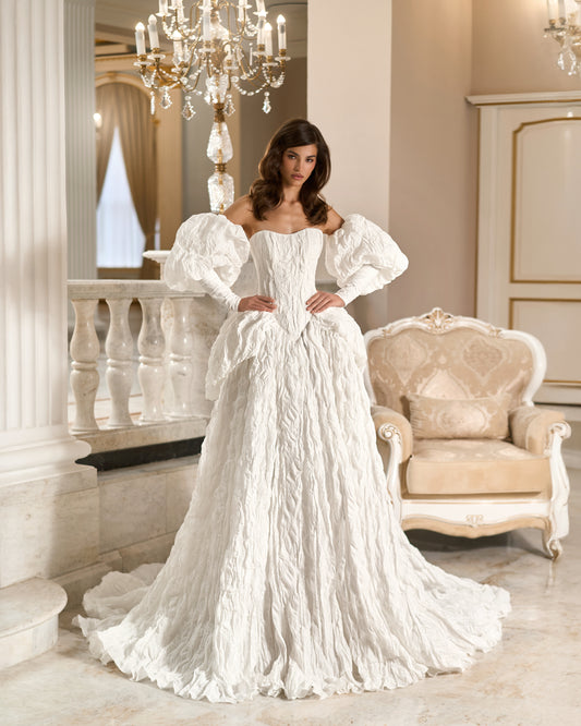 Front view of a white textured taffeta ball gown wedding dress with a basque waist, sweetheart bodice, long puff sleeves and full skirt.