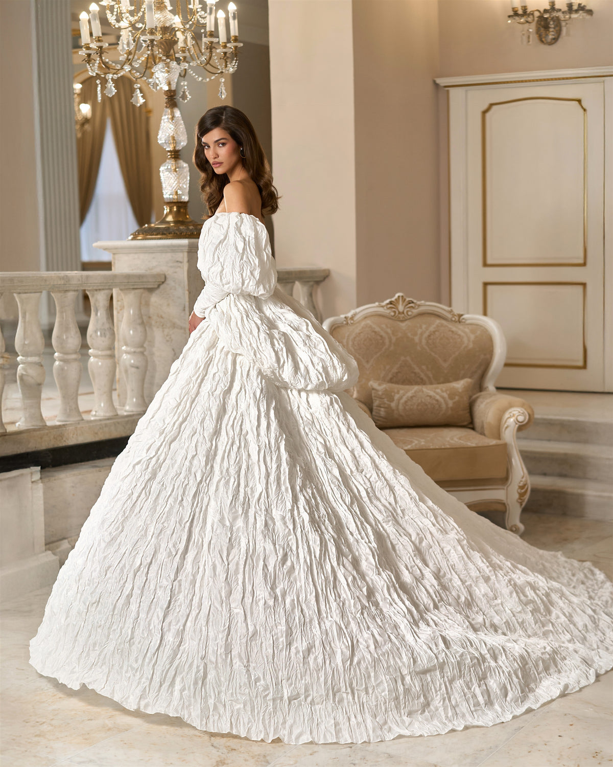 Side and rear view of a white textured taffeta ball gown with puff sleeves, a full skirt and a long trailing train.