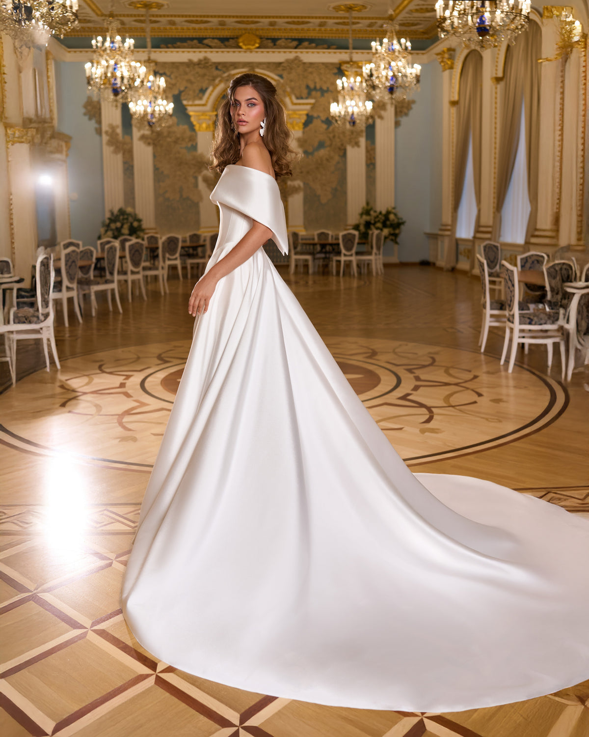 Side view of A-line off-the-shoulder wedding dress with folded cuff and long sweeping train