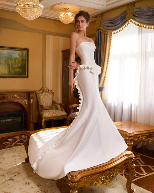 Strapless mermaid wedding dress with waist ruffle and a ruffle running along the train, no bolero