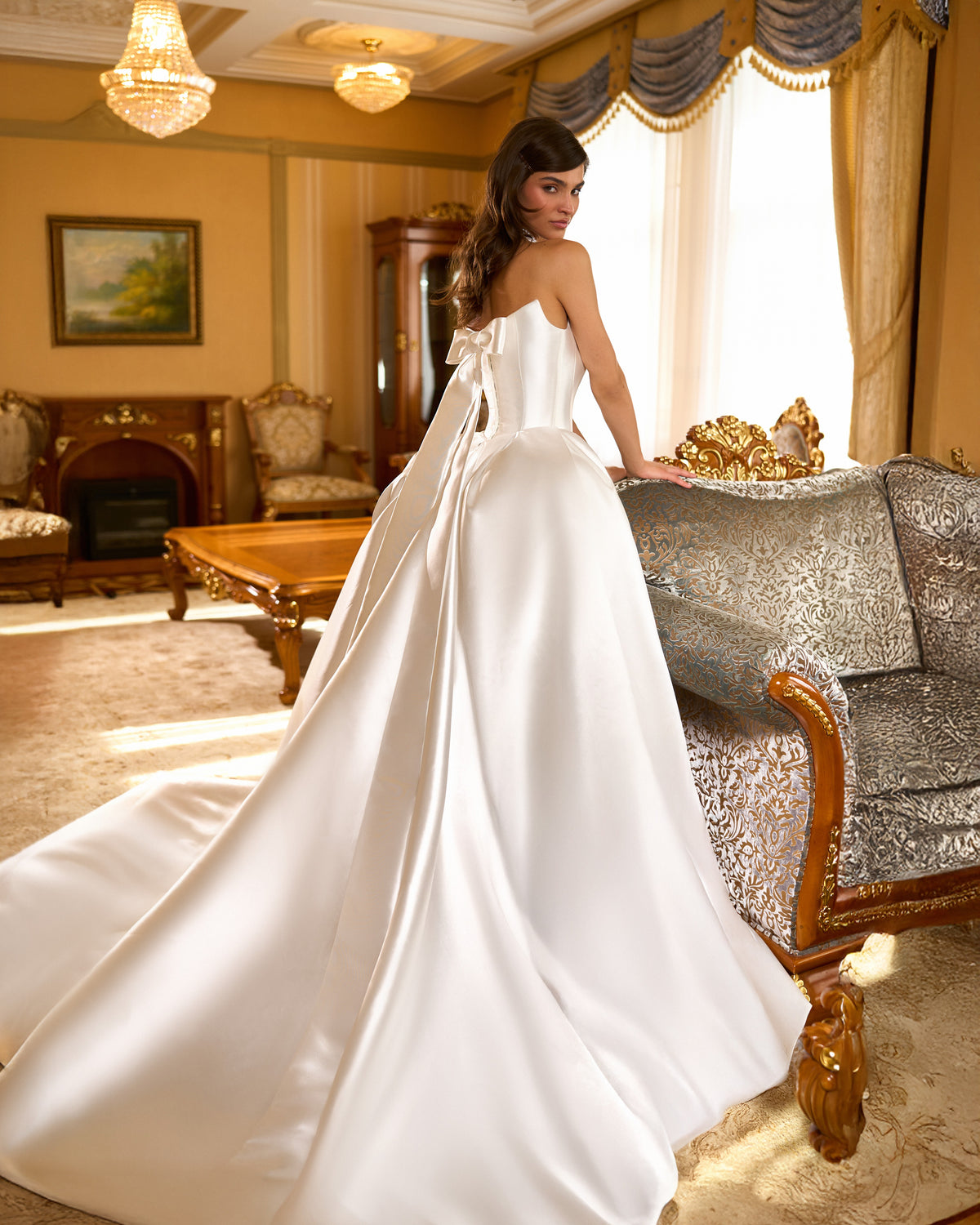 Back view of ball gown wedding dress with back bow, long streamers and sweeping train