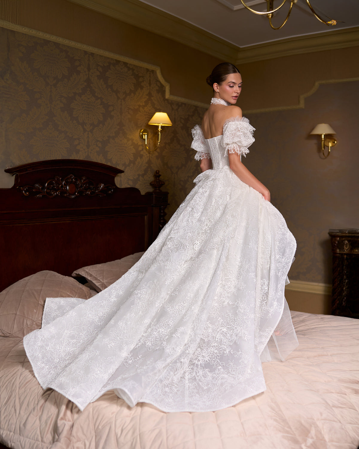Back view of A-line lace wedding dress with puff sleeves, lace choker and sweeping train