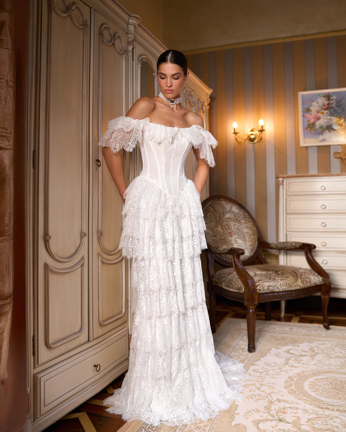 Fit-and-flare lace wedding dress with off-the-shoulder ruffled sleeves, corset bodice and tiered skirt