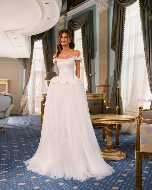 Princess A-line wedding dress with longline Mikado corset, off-the-shoulder wide ribbon straps, pearl hip details, voluminous tulle skirt, and flowing chapel train for elegant bridal look