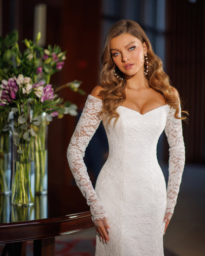 Off the shoulder lace mermaid wedding dress with long sleeves.