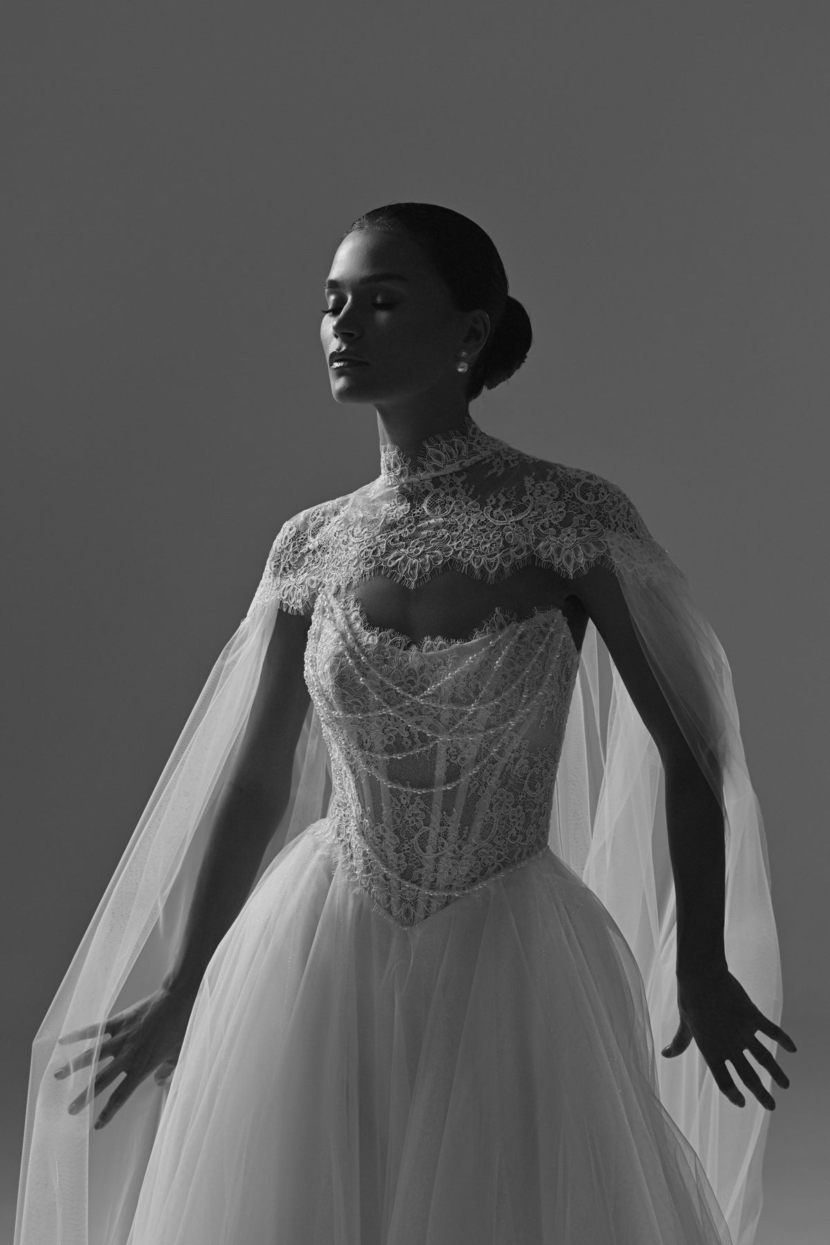 Tulle wedding dress with sheer cape – black and white close-up of the corset and cape