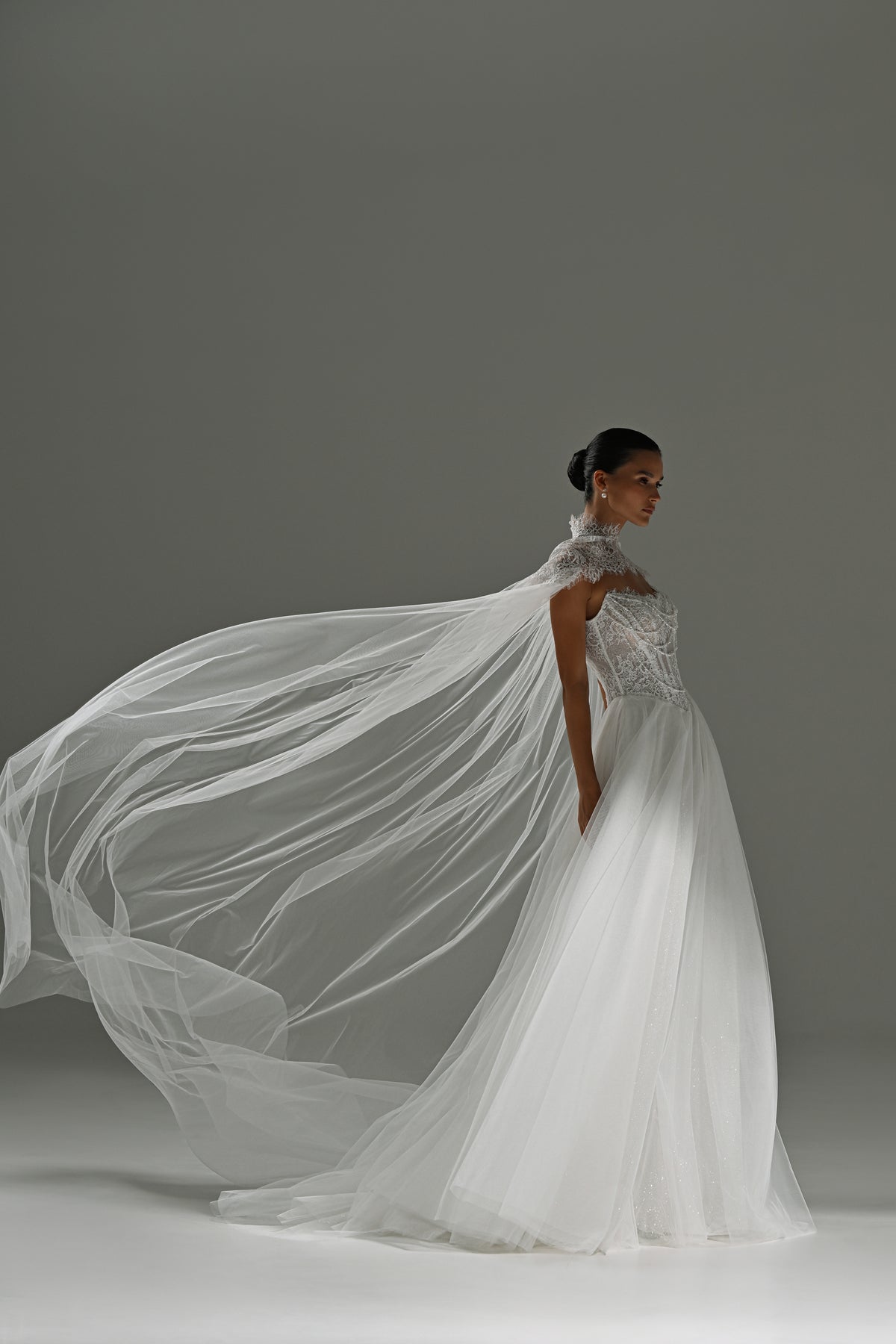 Tulle wedding dress with sheer cape – side view with the cape flowing behind