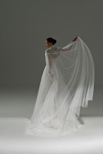 Tulle wedding dress with sheer cape – back three-quarter view with the cape raised