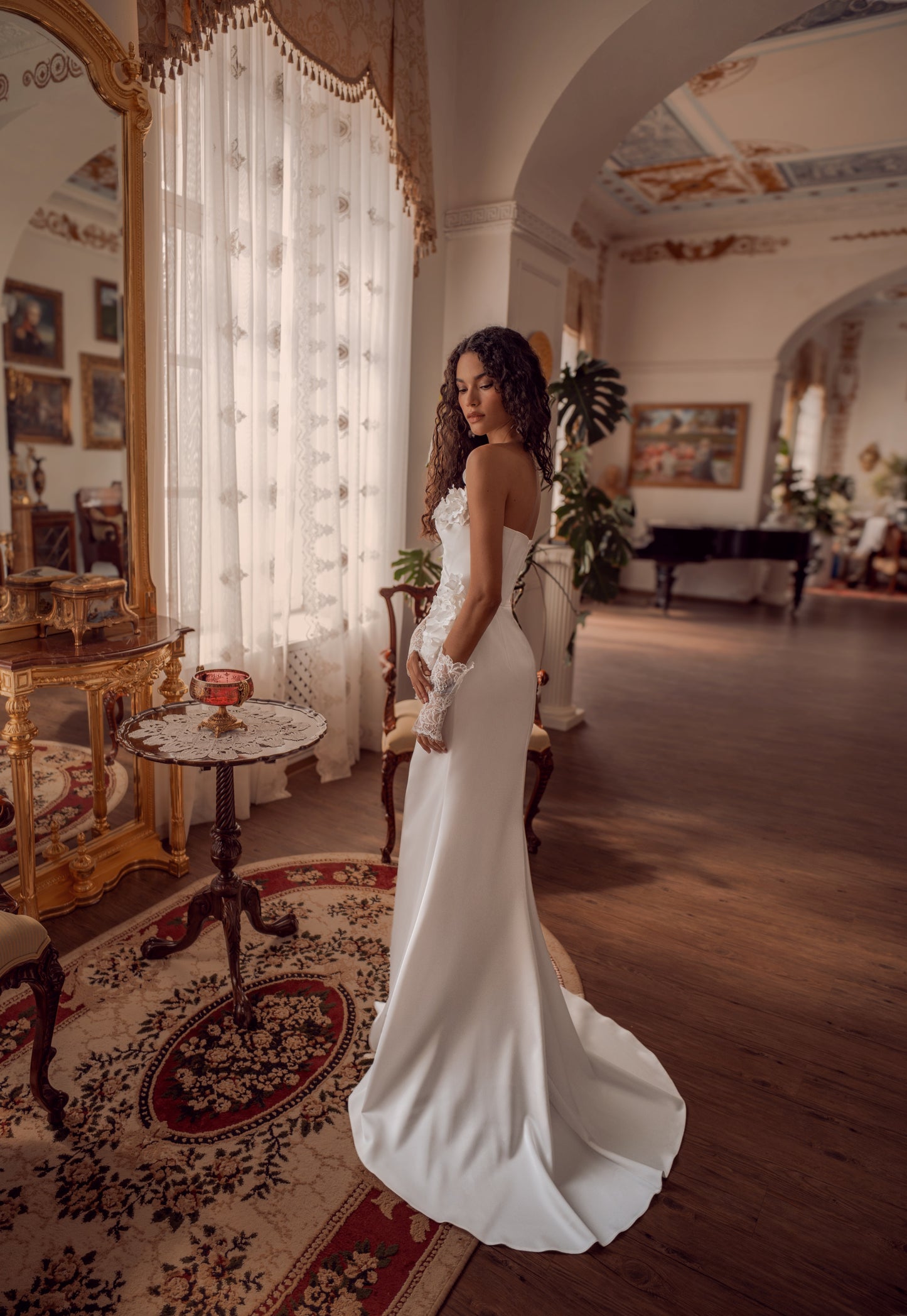 Silk satin wedding gown with asymmetric draped neckline and 3D floral appliqué.