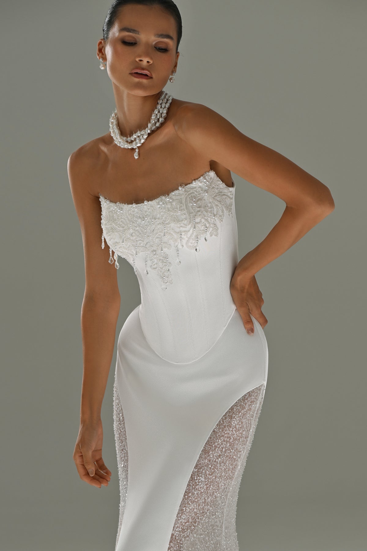 Satin mermaid wedding dress with lace side panels – three-quarter front view with pearl necklace